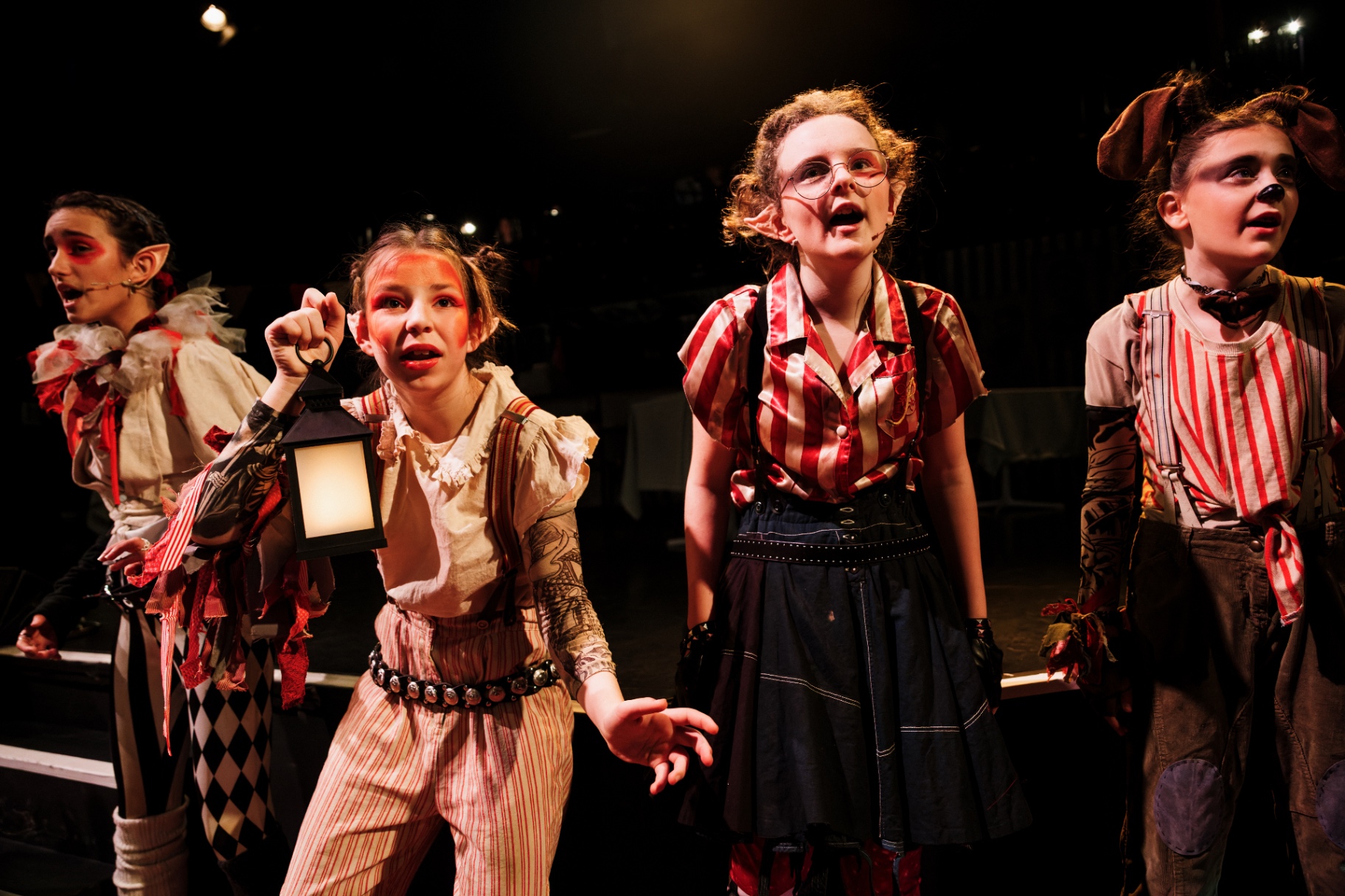 A quartet of goblins holding a lantern, mid-scene.