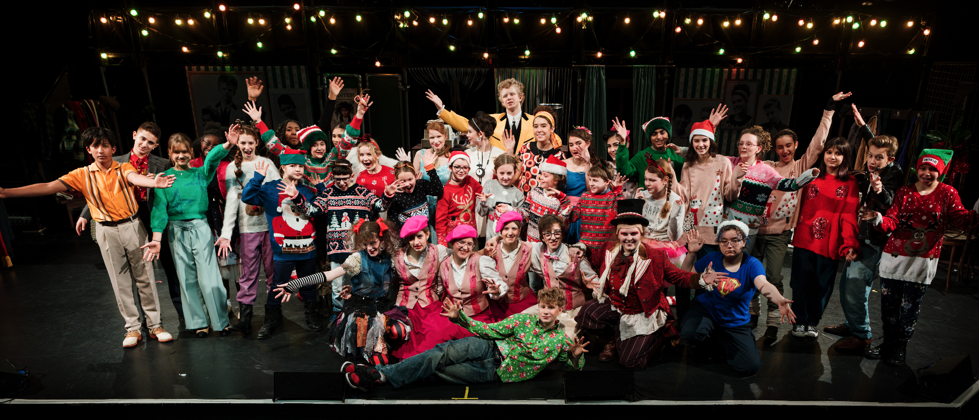 The full company of The Little Zombie Girl on stage in Christmas costume.